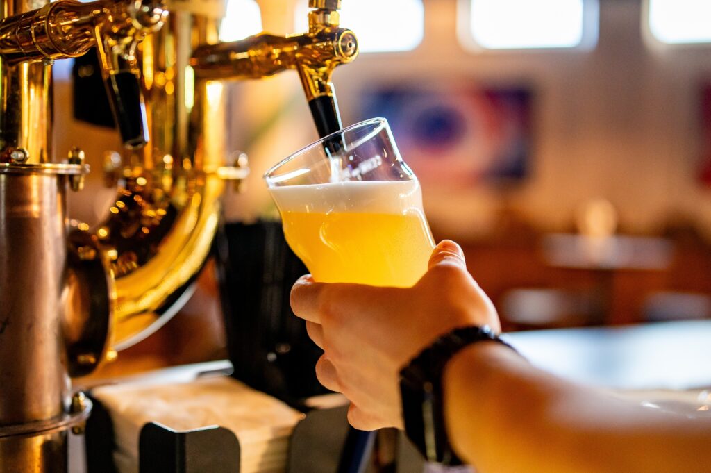 Freshly poured craft beer in a tulip glass at a local brewery taproom