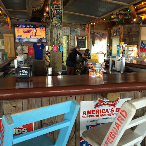 Pleasure Island Tiki Bar at Sportsman Marina exterior view showcasing professional restaurants services in Orange Beach, Alabama