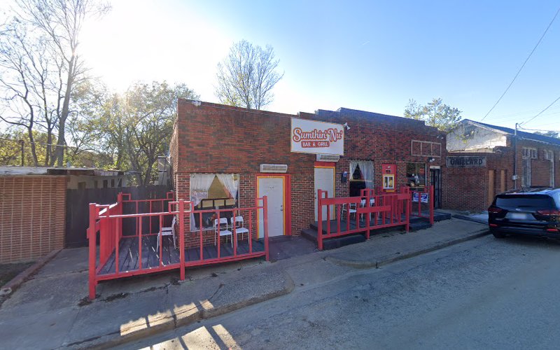 Sumthin' Nu' Bar and Grill exterior view showcasing professional restaurants services in Tuskegee, Alabama